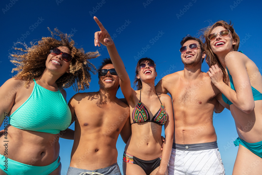 Happy young friends enjoying freedom on Summer vacation