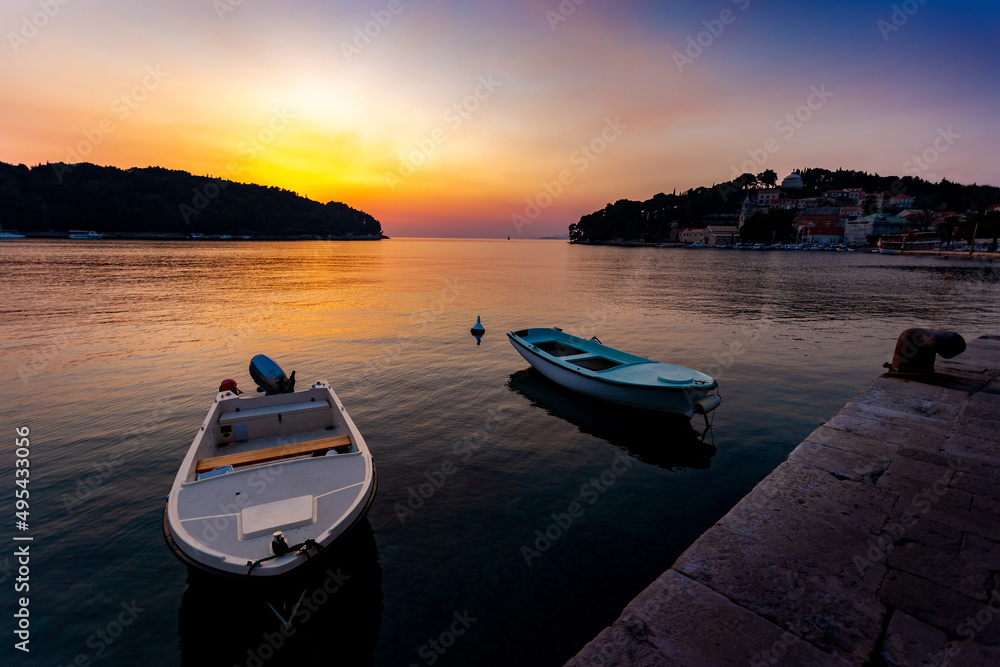 Fishing boats in a sea, near coast. Sunset time. Fishing boats in a sea, near coast. Sunset time.