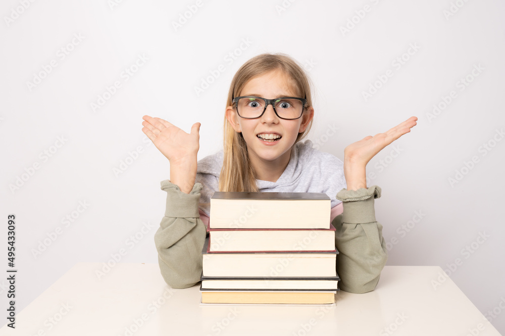 Amazed girl in glasses with pile of books isolated on white background. Amazed girl in glasses with pile of books isolated on white background.