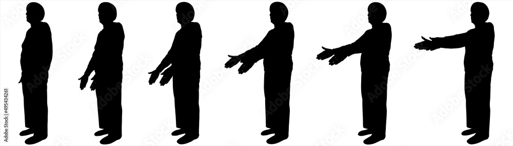An elderly woman is standing half sideways. An older woman with a short haircut, in long trousers, in a blouse. Sport. Warm-up for older people. The movement of two hands from below and to the top.