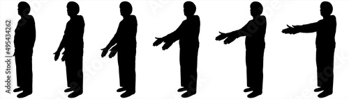 An elderly woman is standing half sideways. An older woman with a short haircut, in long trousers, in a blouse. Sport. Warm-up for older people. The movement of two hands from below and to the top.