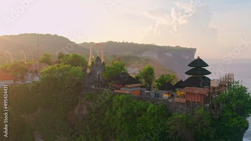 Wallpaper Mural Bali's Most Iconic Landmark and popular tourist attraction Uluwatu Temple one of six key Balinese hindu temple perched on top mountain cliff on background amazing nature Bali, Indonesia 4K Aerial vie Torontodigital.ca