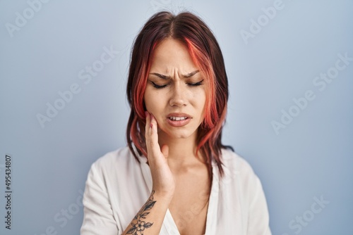 Young caucasian woman wearing casual white shirt over isolated background touching mouth with hand with painful expression because of toothache or dental illness on teeth. dentist