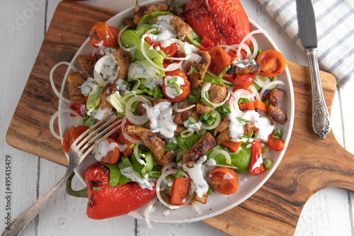Low carb salad with roasted vegetables  pan fried meat and yogurt sauce