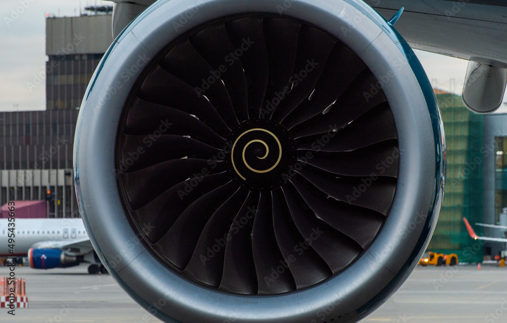 Turbine engine of a modern jet passenger aircraft at an international airport.