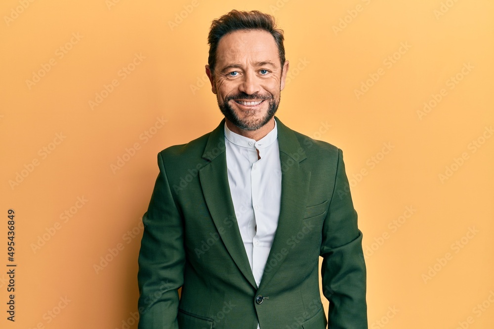 Middle age man wearing business suit with a happy and cool smile on face. lucky person. Middle age man wearing business suit with a happy and cool smile on face. lucky person.