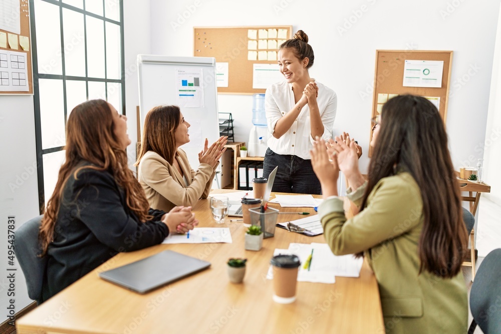 Group of young businesswomen smiling and clapping to partner at the office. Group of young businesswomen smiling and clapping to partner at the office.
