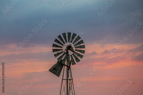 Black windmill under sunset sky photo