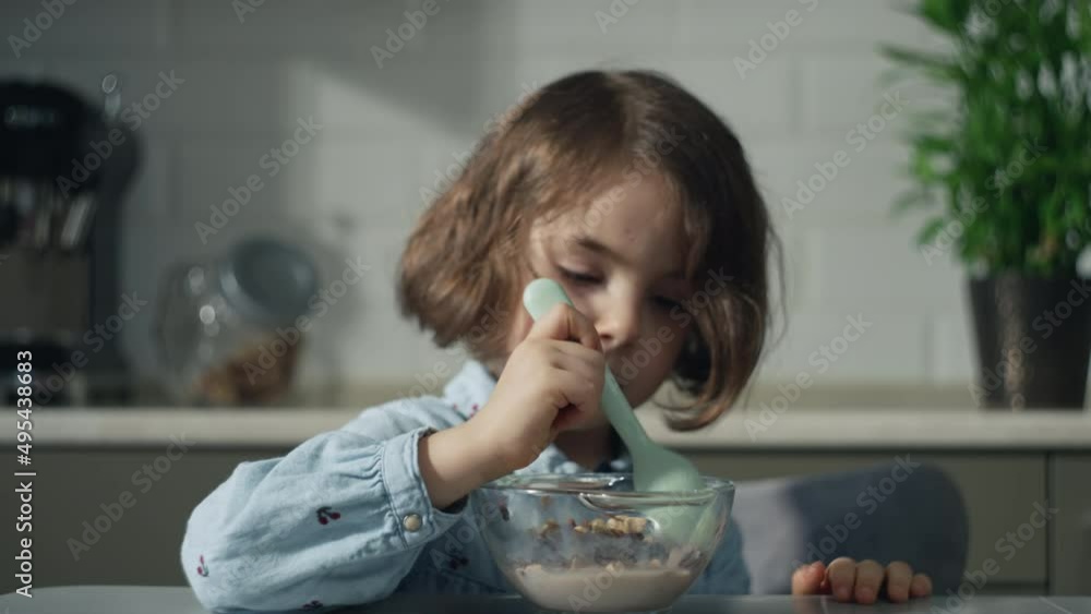 Little girl eating her breakfast, sweet cereal. High quality 4k footage Little girl eating her breakfast, sweet cereal. High quality 4k footage