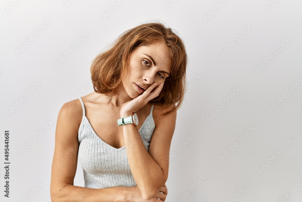Beautiful caucasian woman standing over isolated background thinking looking tired and bored with depression problems with crossed arms. Beautiful caucasian woman standing over isolated background thinking looking tired and bored with depression problems with crossed arms.