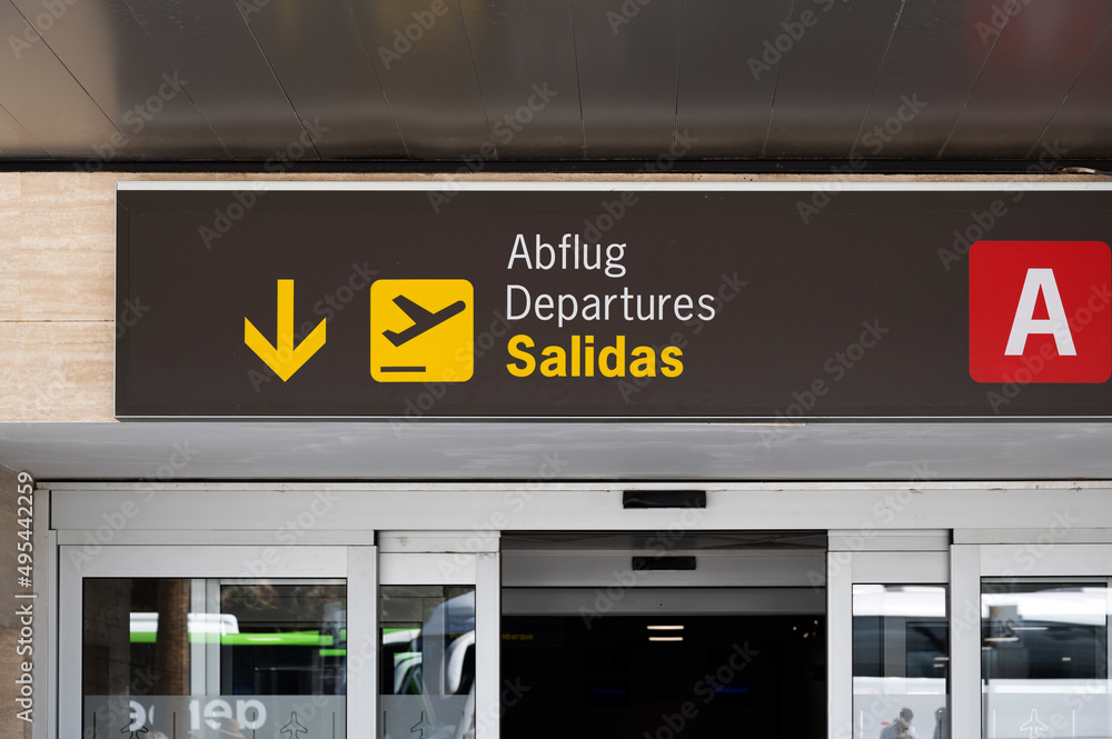 Entrance door of a Spanish International airport with departures, salidas sign. Entrance door of a Spanish International airport with departures, salidas sign.