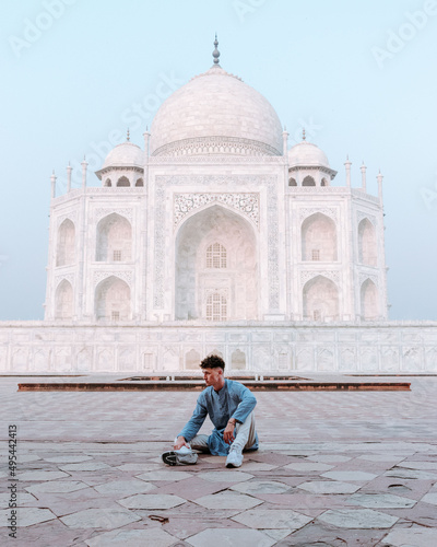 Man sitting in front of Taj Mahal, Agra, India
