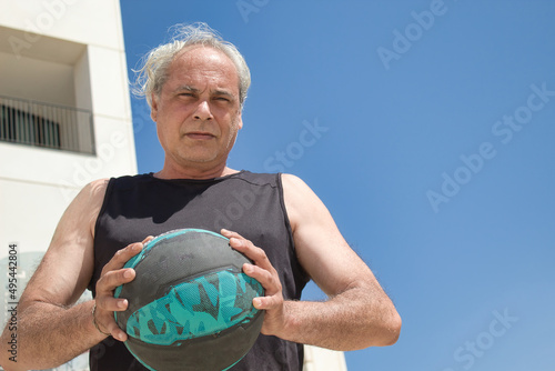 Wallpaper Mural Mature man playing basketball outdoor Torontodigital.ca