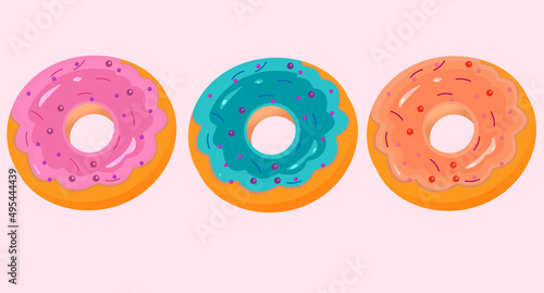 Set of three colored donates on pink background photo