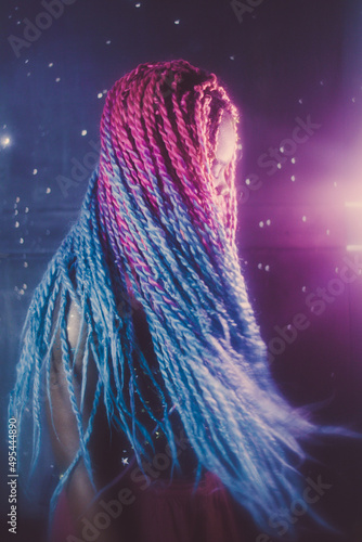 Portrait of young Black woman with colorful dreads in Nebula themed studio