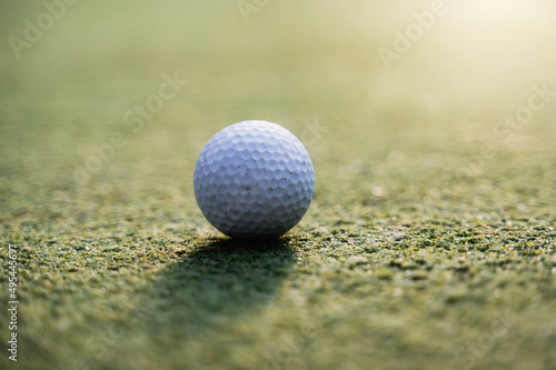 Close-up golf ball on grass.