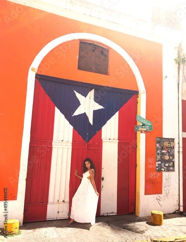 South Asian woman in light dress standing beside art museum in Puerto Ricco photo