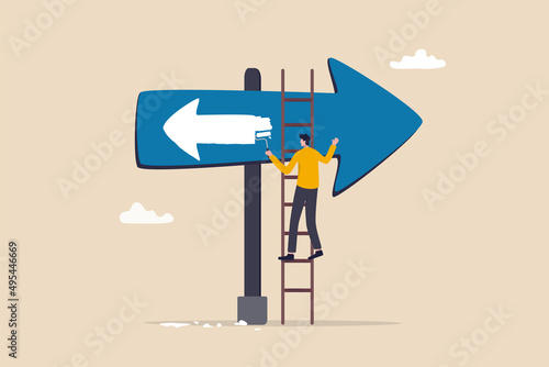 Change to opposite direction, hesitate business decision to change to better opportunity, conflict or reverse direction, career path concept, businessman paint opposite direction arrow on arrow sign. photo