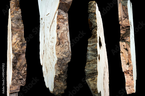 Pieces of wood isolated on black background. Texture of a polished cut of a tree close-up. Side view. Woodworking, carpentry production.