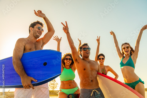 Beach celebrations for happy young friends in swimwear
