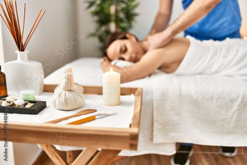 Young woman relaxed reciving back massage at beauty center.