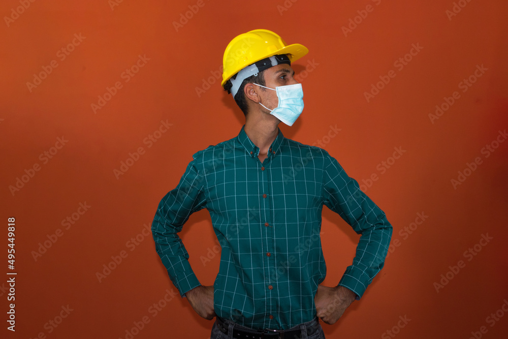 Worker with yellow helmet and pandemic mask isolated. Worker with yellow helmet and pandemic mask isolated.