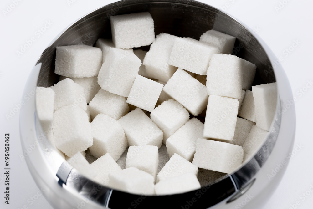 Metal bowl with cubes of white refined sugar for tea and coffee top view close-up Metal bowl with cubes of white refined sugar for tea and coffee top view close-up