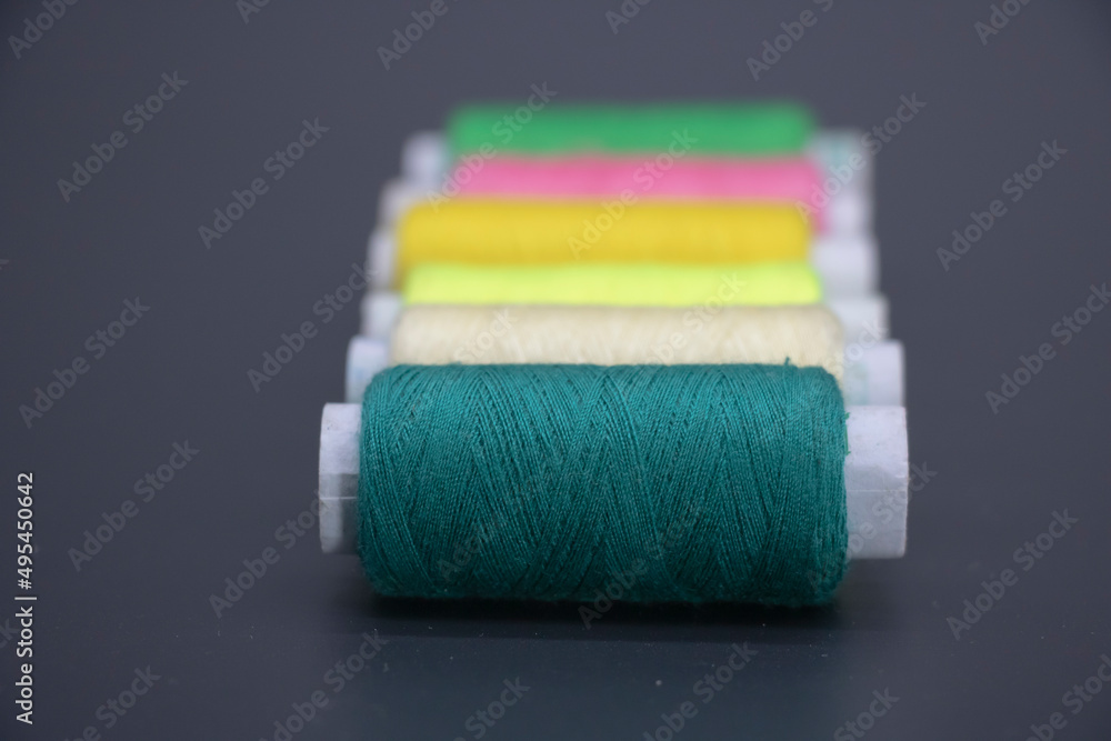 different color yarn on spool, yarn on tube, cotton, wool, isolate on black background different color yarn on spool, yarn on tube, cotton, wool, isolate on black background