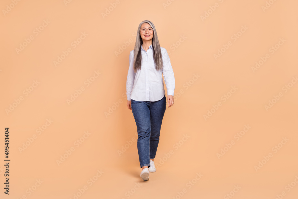Full body photo of cheerful pretty woman chief leader go smart casual isolated over beige color background Full body photo of cheerful pretty woman chief leader go smart casual isolated over beige color background