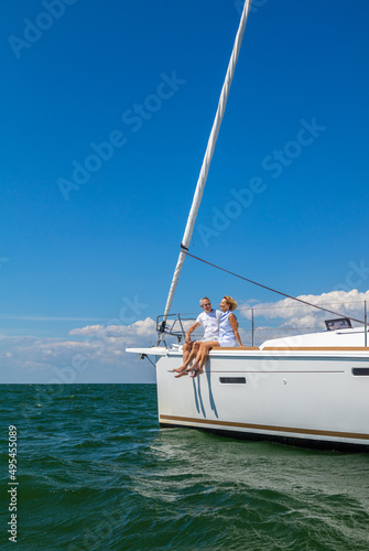 Successful senior couple relaxing outdoors on luxury yacht