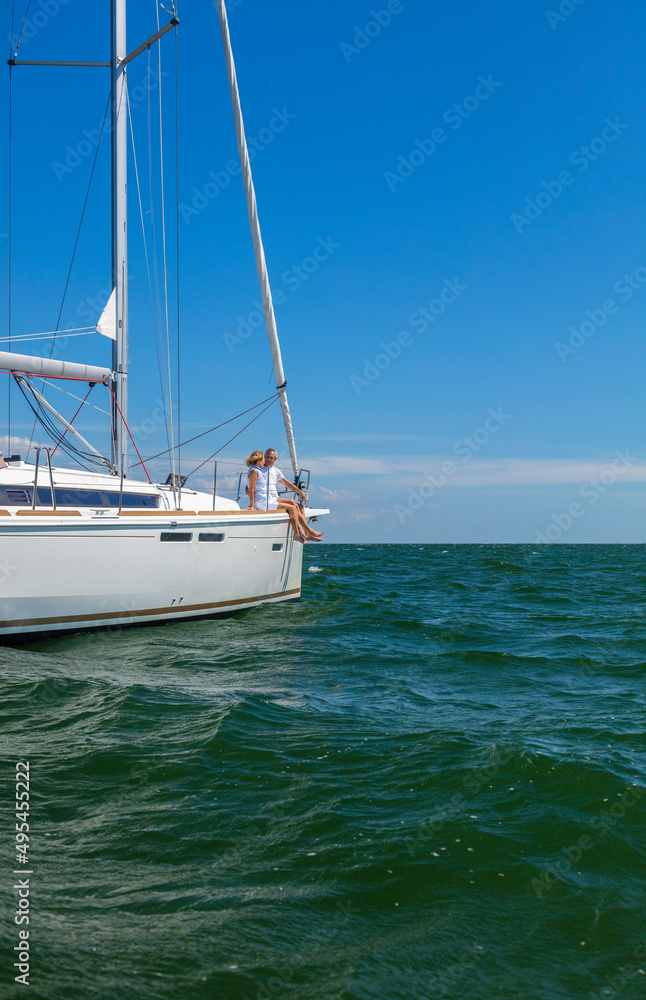 Senior couple relaxing on yacht sailing the ocean