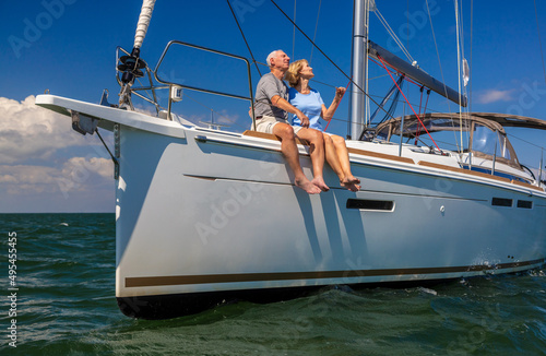 Adventurous couple enjoying relaxed lifestyle on luxury yacht