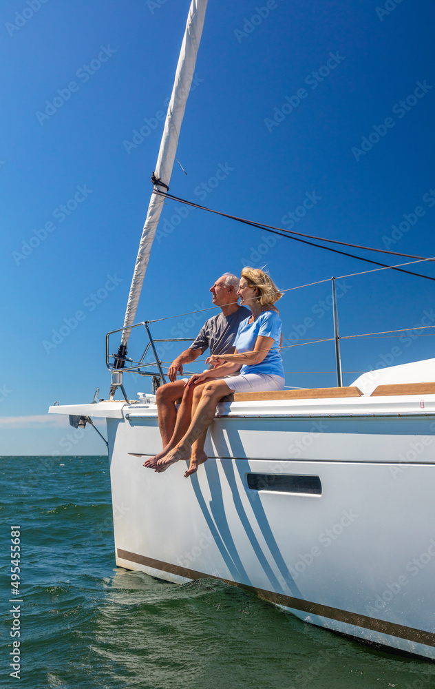 Obraz premium Happy retired couple on vacation relaxing on yacht