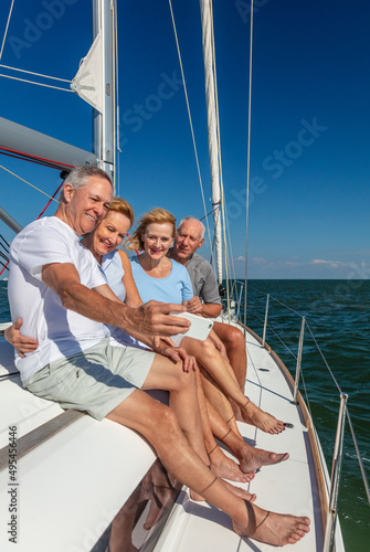 Senior American friends taking photograph on luxury yacht © Spotmatik