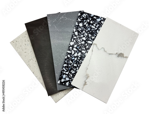 different quartz samples swatch for kitchen counter top with precise processed edges isolated on background with clipping path. multi color and pattern of artificial stones (focused at black pebble). photo