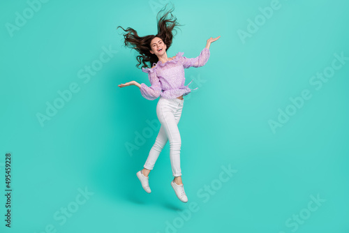 Full body photo of satisfied adorable person hands throw hair have fun isolated on turquoise color background