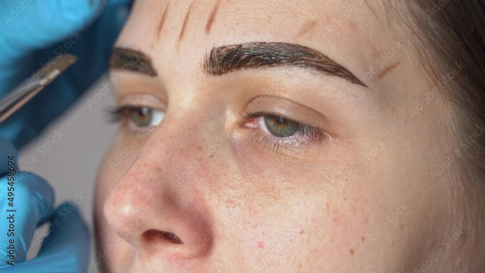 female eyebrows and eyes closeup, eyebrow paint is applied with a