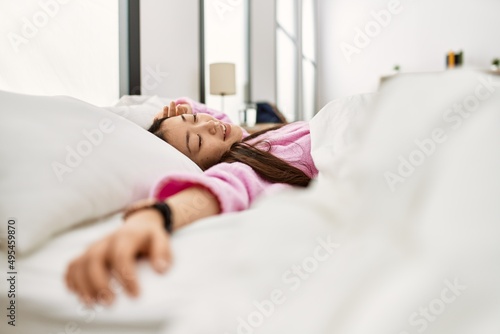 Young chinese girl sleeping on the bed at bedroom.