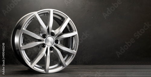 Fotografía new grey alloy wheels on a dark textured black background