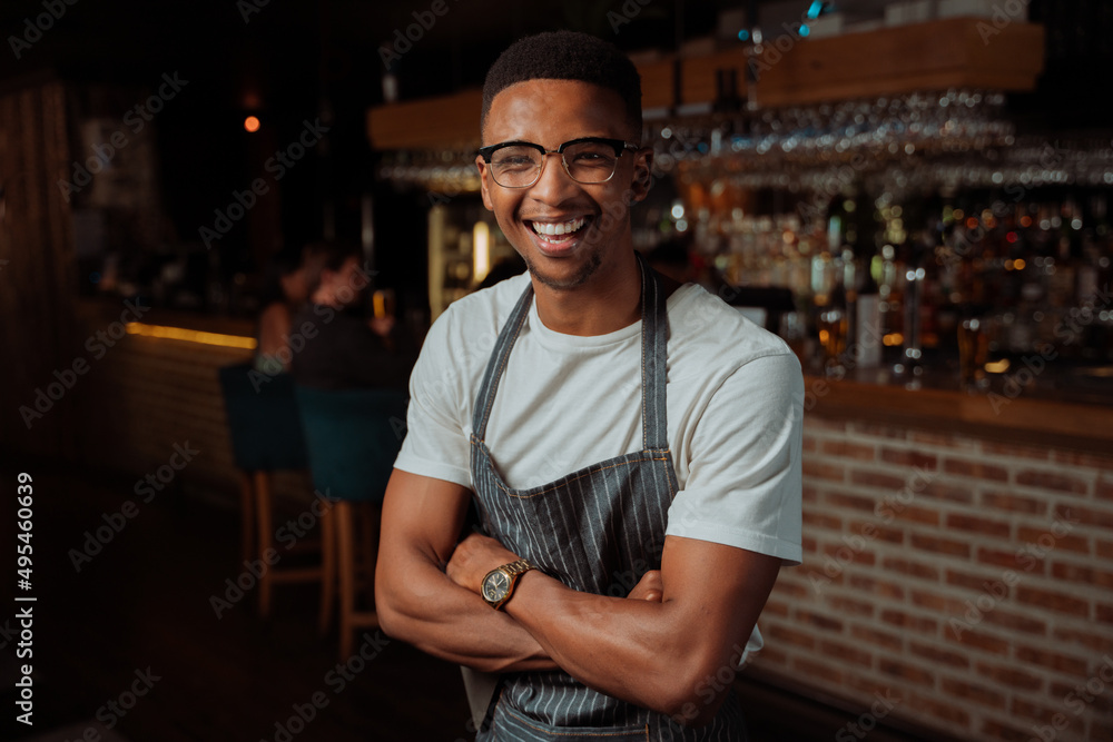 Portrait of Male waiter laughing while at work with apron Portrait of Male waiter laughing while at work with apron
