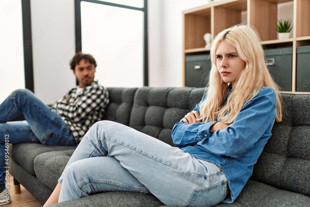 Obraz premium Young couple angry sitting on the sofa in silence at home.