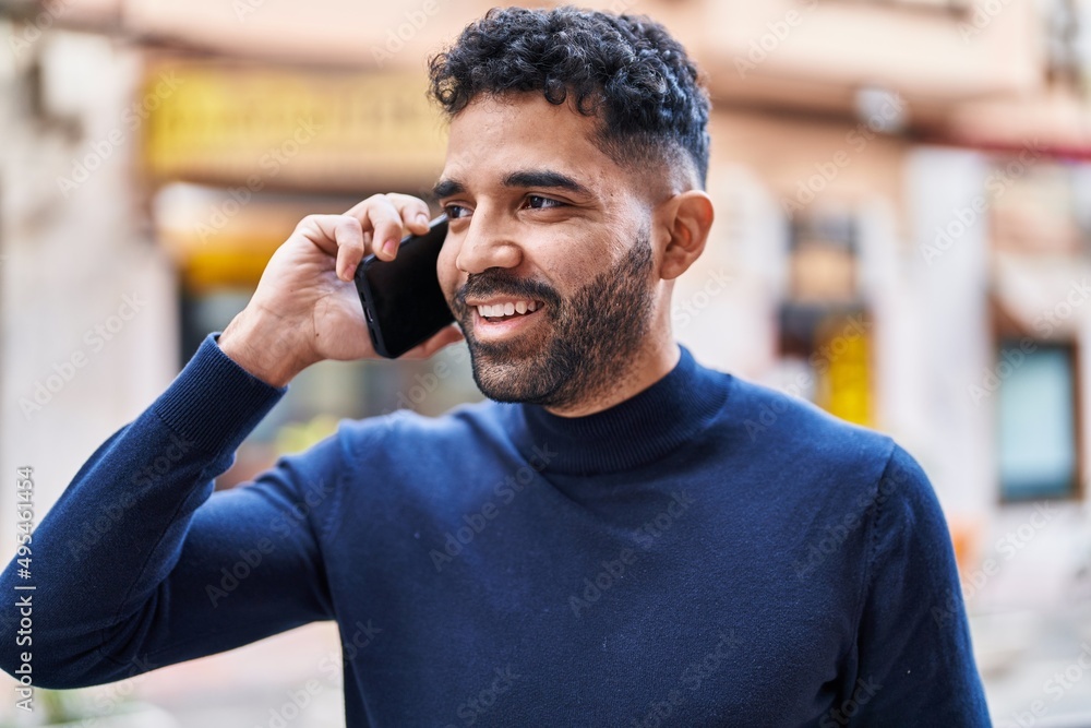 Young hispanic man smiling confident talking on the smartphone at street Young hispanic man smiling confident talking on the smartphone at street
