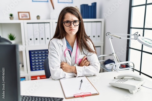 Young doctor woman wearing doctor uniform and stethoscope at the clinic skeptic and nervous  frowning upset because of problem. negative person.