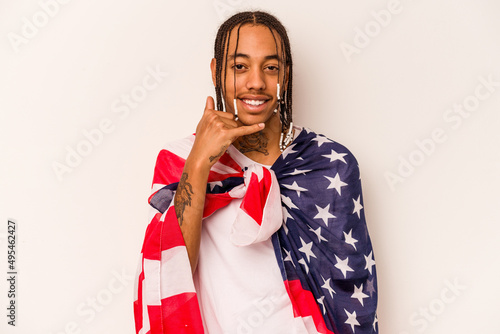 Young African American man holding a American flag isolated on white background showing a mobile phone call gesture with fingers.