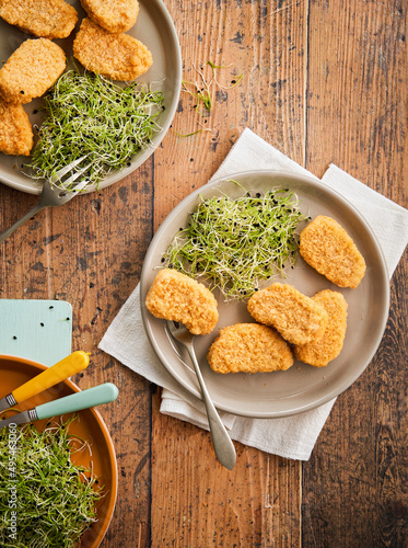 Vegetarian Nuggets,Vegan Dipping, Sauce and microgeens brotss on a wooden background with space for text, selective focus. Healthy Diet, Protein Vegetarian Meals concept, alternative meat products.  photo