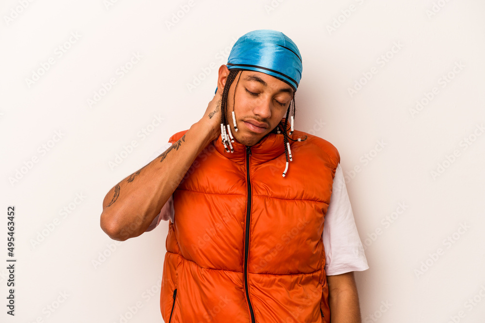 Young African American man isolated on white background having a neck pain due to stress, massaging and touching it with hand. Young African American man isolated on white background having a neck pain due to stress, massaging and touching it with hand.