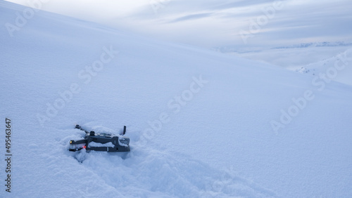 Drone crashed in the snow high up on a mountain