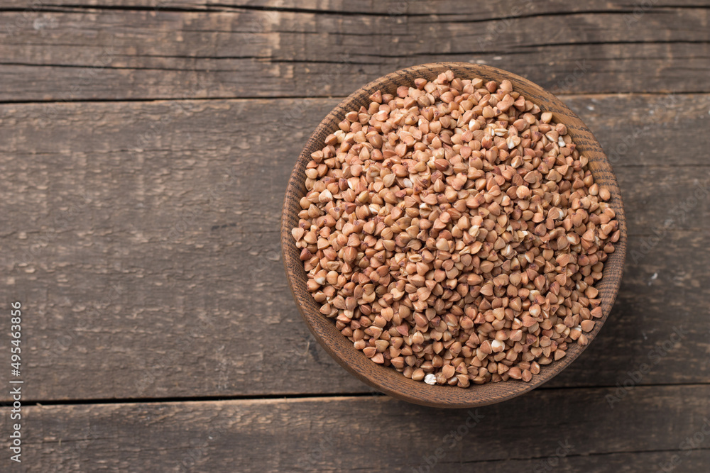 Buckwheat groats on wooden background. Healthy cereal concept. Buckwheat groats on wooden background. Healthy cereal concept.