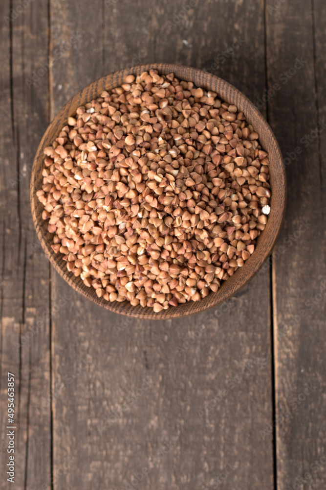 Buckwheat groats on wooden background. Healthy cereal concept. Buckwheat groats on wooden background. Healthy cereal concept.
