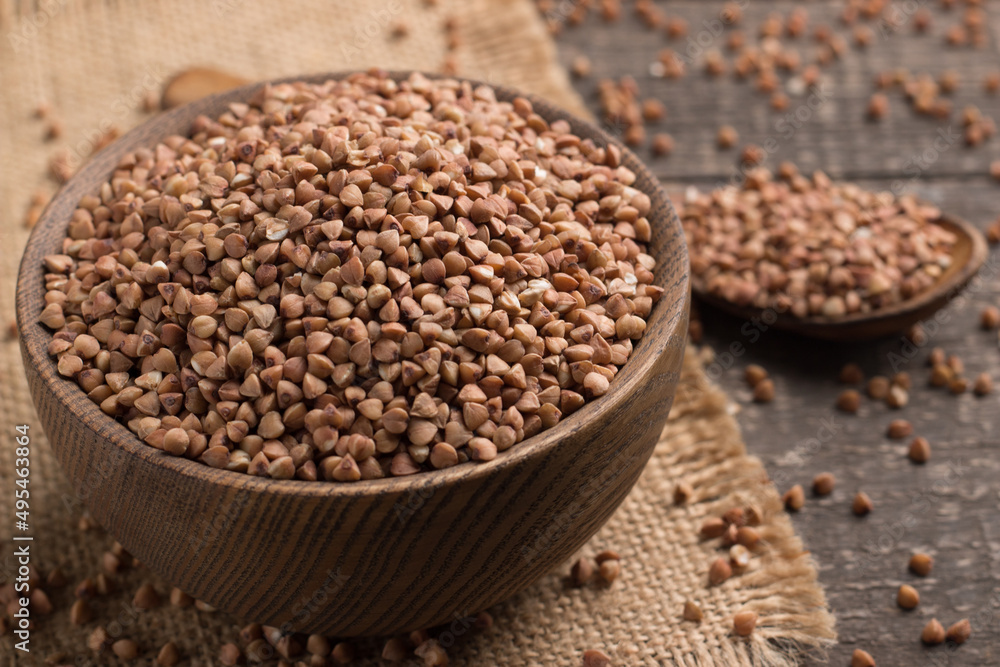 Buckwheat groats on wooden background. Healthy cereal concept. Buckwheat groats on wooden background. Healthy cereal concept.